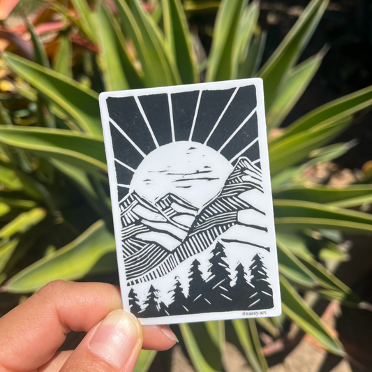 Black and white mountain sticker in front of green plants