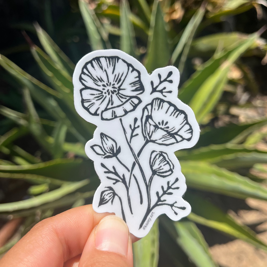Black and white floral California poppy flower sticker with green plants in the background